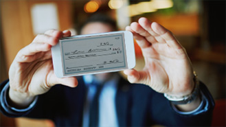 man using his cellphone to deposit a check