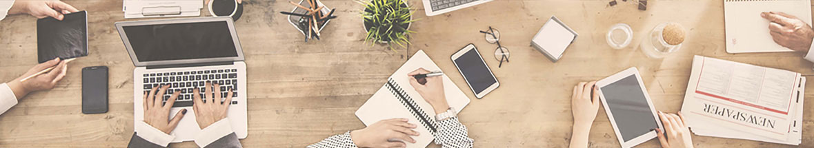 overhead shot of people working at a team work desk