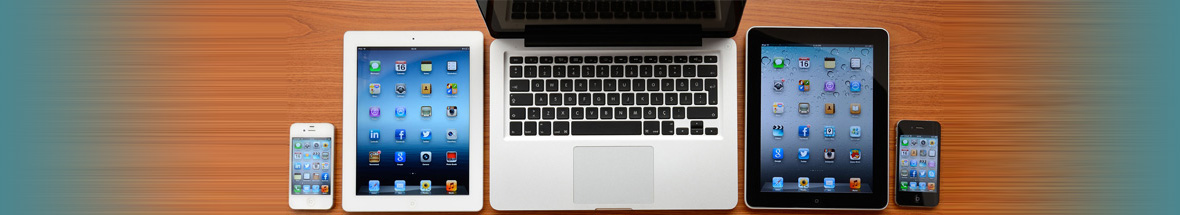 overhead shot of a laptop, tablets, and smart phones