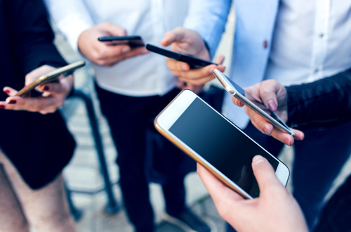 group of people holding tablets