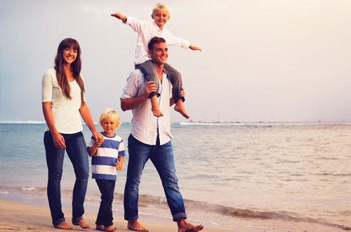 family walking on the beach