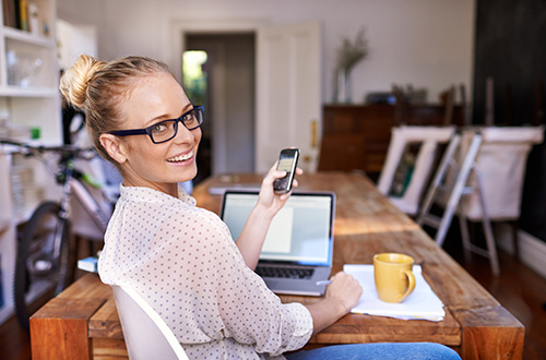 smiling woman holding a phone